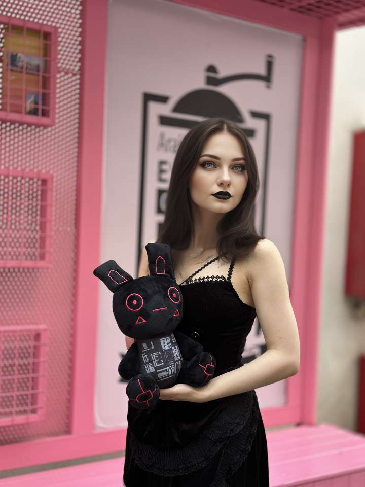 A Girl Hugging A Black Cyber Goth Bunny Plush