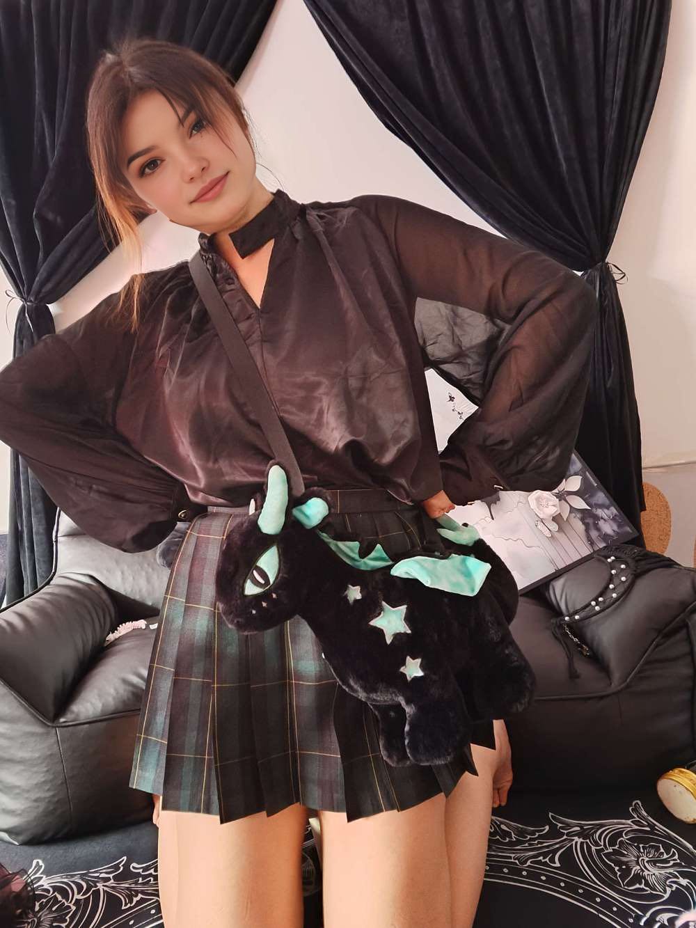 A Girl Hugging a Black Dragon Plush Handbag