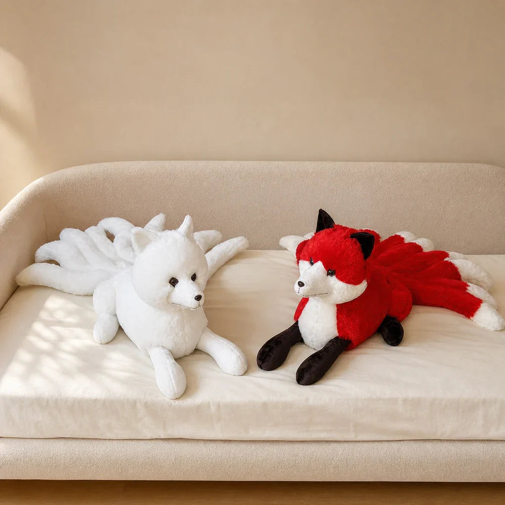White and Red Nine-Tailed Fox Stuffed Animals on a Daybed