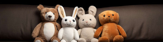 four plush toys sitting on the sofa