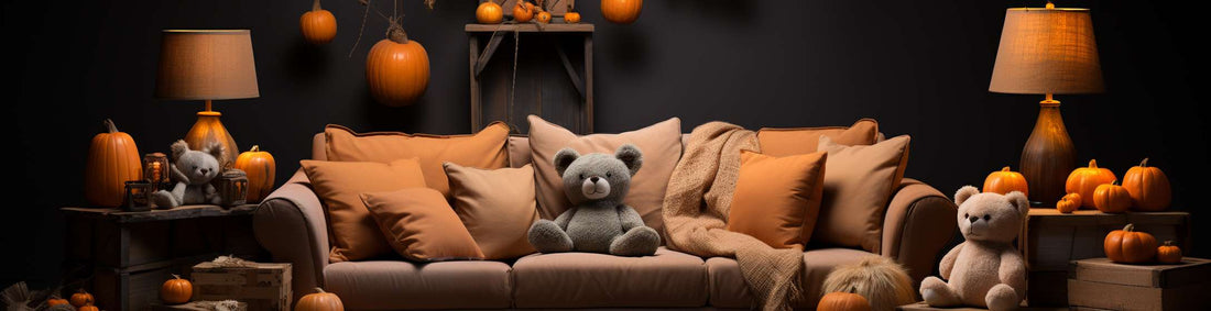 three plushies sitting on the sofa with some pumpkins
