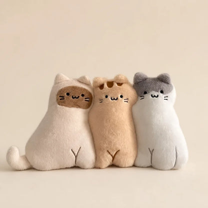 Three Cute Cat Animal Pillow Plushies on Warm Beige Background
