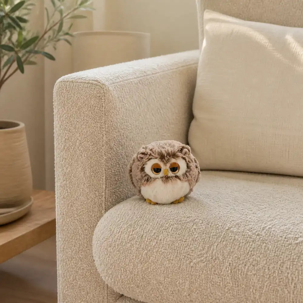 Brown Sleepy Owl Plush on a Cream Sofa