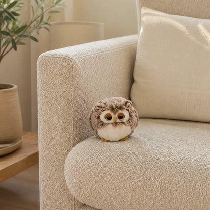 Brown Sleepy Owl Plush on a Cream Sofa