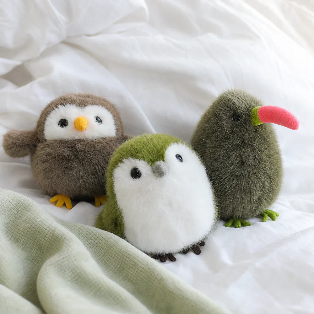 Mini Bird Plush Collection on a Bedroom Bed
