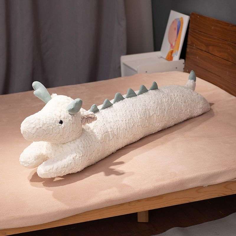 white dragon pillow on bed