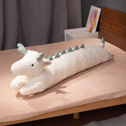 white dragon pillow on bed
