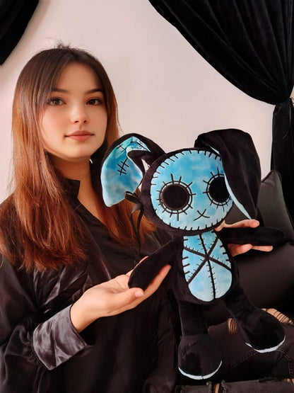 A girl hugging a Goth Voodoo Blue Bunny Plush