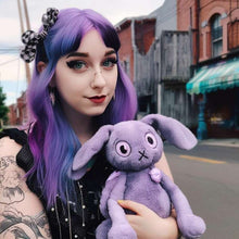 A girl and a purple rabbit plush