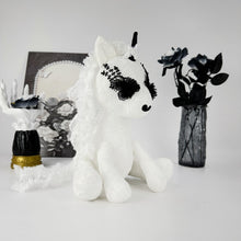 Side view of white lace fabric unicorn stuffed animal