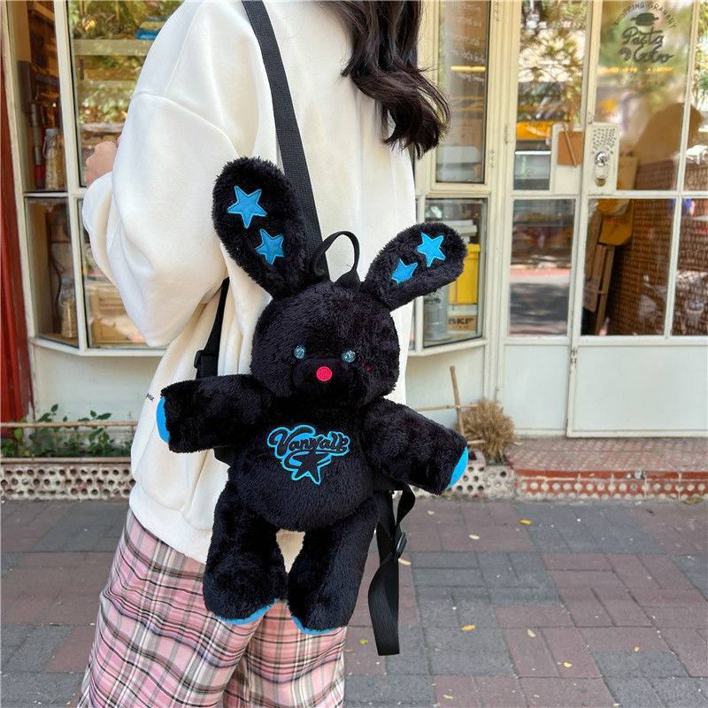 Pink bunny plush backpack with cute ears and a heart-shaped patch, perfect for kids