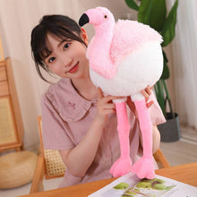 A large pink flamingo plush toy