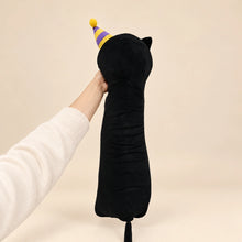 Back view of the long black birthday cat plush, showing its party hat, center seam, and visible tail.