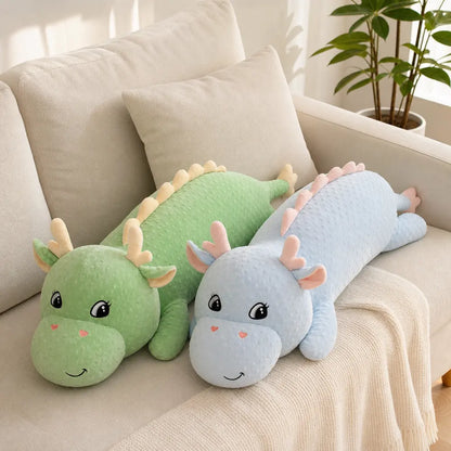 Blue and Green Long Dinosaur Plush Toys on a Cream Sofa