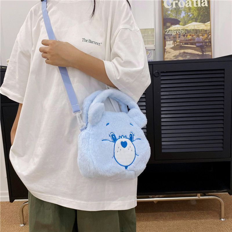 Blue Bear plush handbag with a heart-shaped patch, perfect for kids.