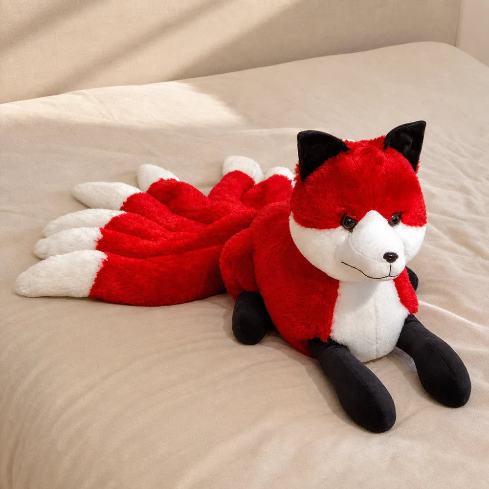 Red and White Nine-Tailed Fox Stuffed Animal on a Cozy Bed