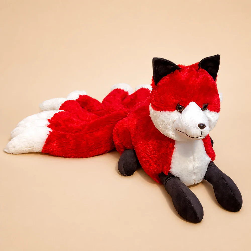 Red and White Nine-Tailed Fox Stuffed Animal on a Warm Beige Background