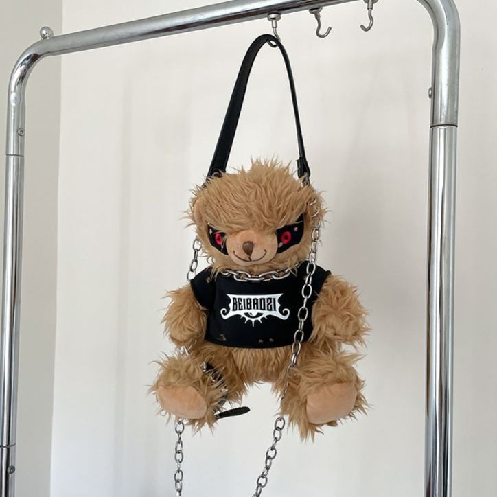 Black teddy bear backpack with red eyes, metal chains, and a studded strap, perfect for adults.