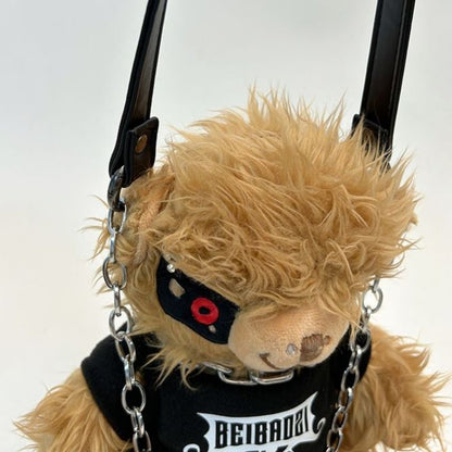 Black teddy bear backpack with red eyes, metal chains, and a studded strap, perfect for adults.