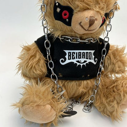 Black teddy bear backpack with red eyes, metal chains, and a studded strap, perfect for adults.