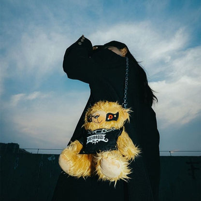 Black teddy bear backpack with red eyes, metal chains, and a studded strap, perfect for adults.