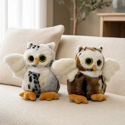 White and Brown Flying Owl Stuffed Animals on a Cream Sofa