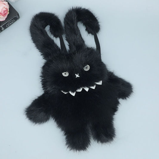 Spooky black bunny plush backpack with sharp teeth and stitched eyes.