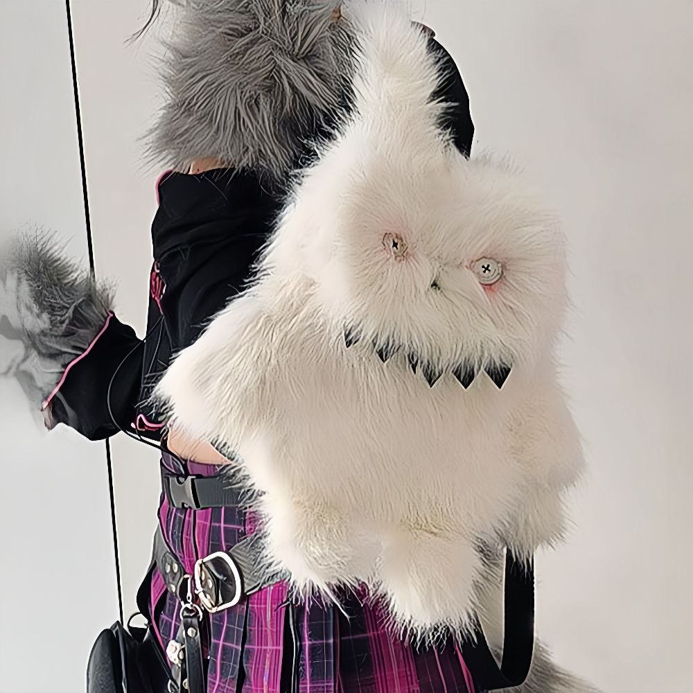 Spooky white bunny plush backpack with sharp teeth and stitched eyes.