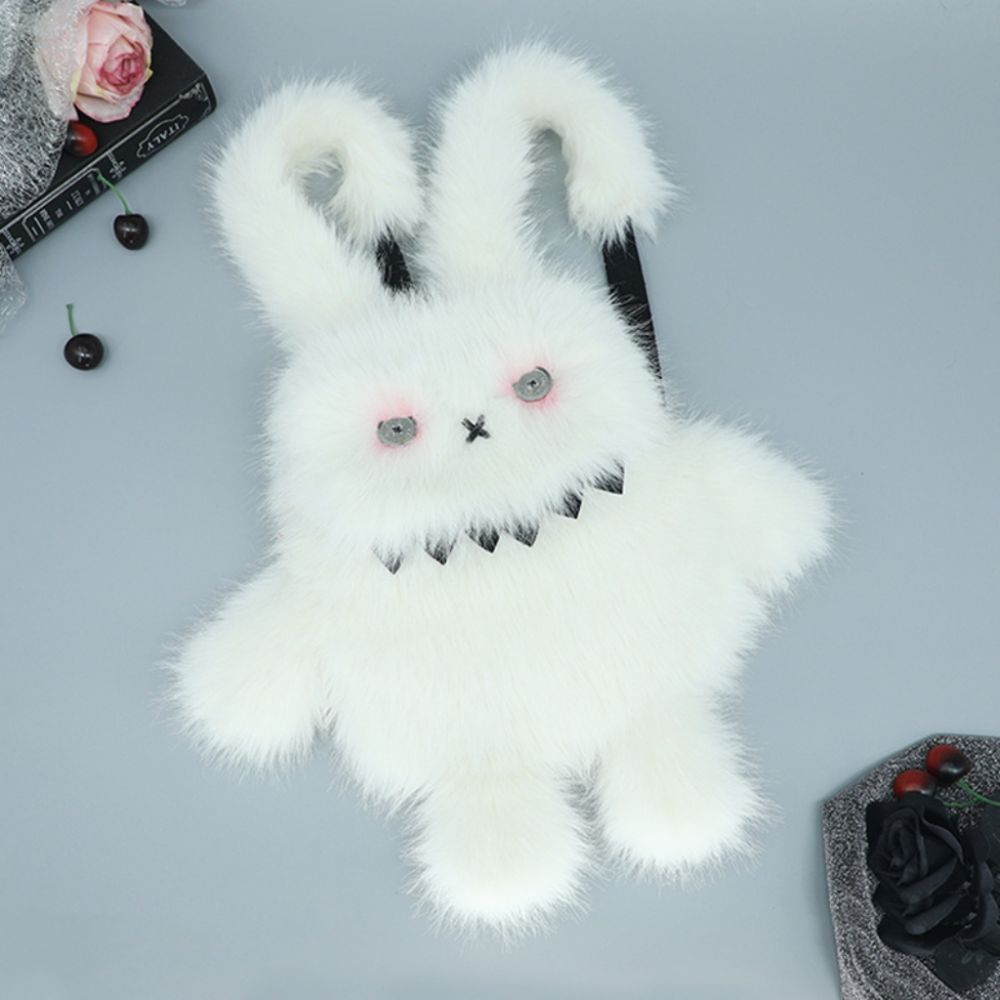 Spooky white bunny plush backpack with sharp teeth and stitched eyes.