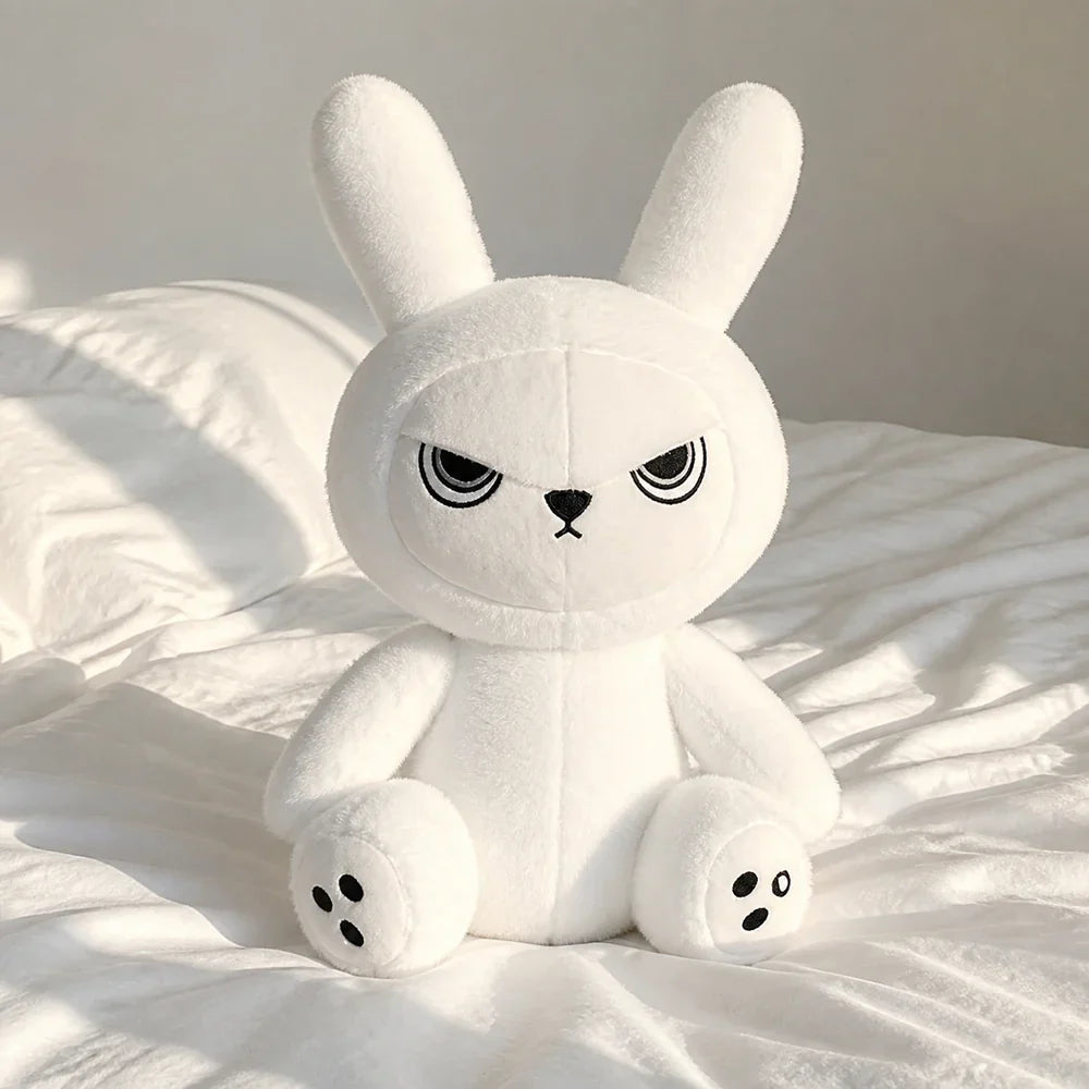 White Gothic Bunny Plush on a White Bed