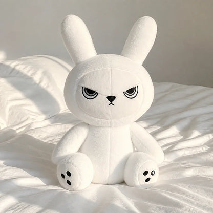 White Gothic Bunny Plush on a White Bed
