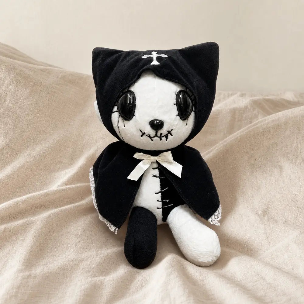 Black Gothic Cat Plush on a Warm Beige Bed