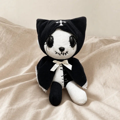 Black Gothic Cat Plush on a Warm Beige Bed