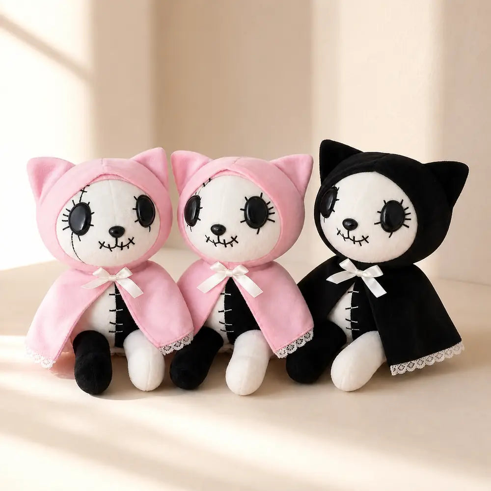 Pink and Black Gothic Cat Plushes on a Cream Table