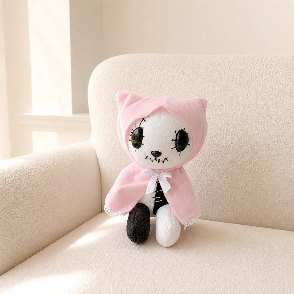 Pink Gothic Cat Plush on a Cream Sofa