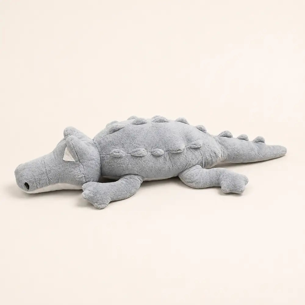 Gray 100cm crocodile plush side view on an ivory studio background