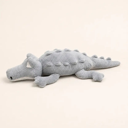 Gray 100cm crocodile plush side view on an ivory studio background
