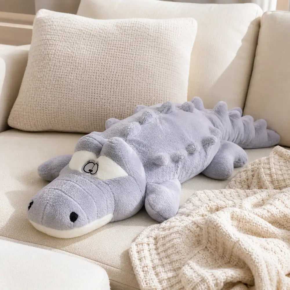 Gray 100cm crocodile plush on a cozy cream sofa
