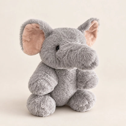 Gray elephant plush in a front three-quarter view with pink inner ears and rounded feet.