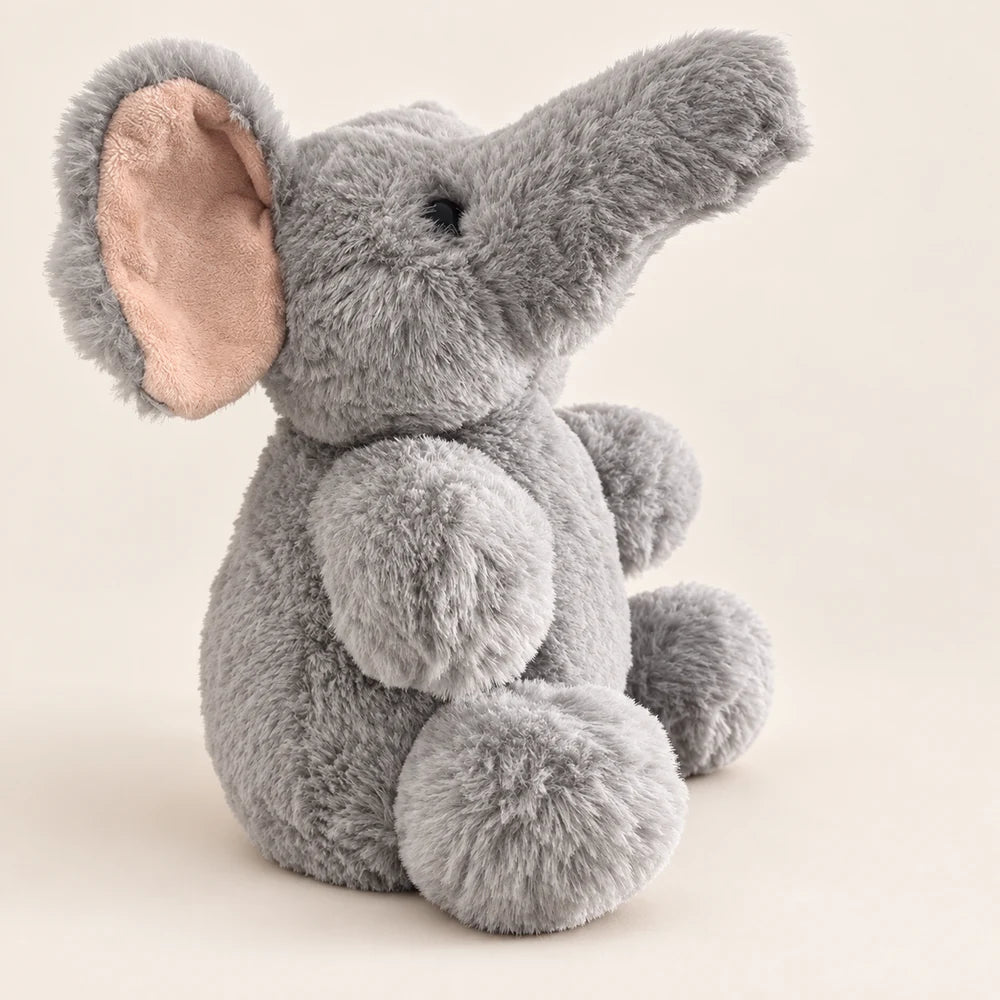 Side view of the gray elephant plush showing its raised trunk, large ear, and rounded body.