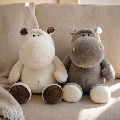 Gray and Cream Brown Hippopotamus Plush Stuffed Animals on a Taupe Sofa