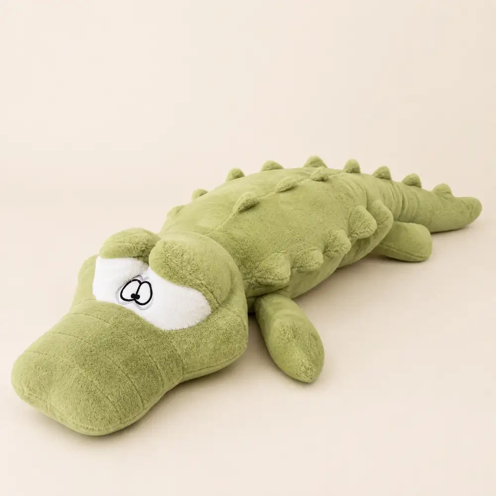 Light green 100cm crocodile plush low angle view on an ivory studio background