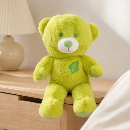 Lime green leaf teddy bear plush on a bright minimalist bedside table