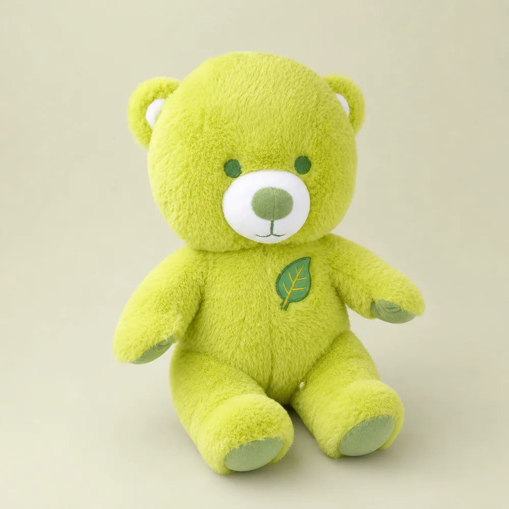 Lime green leaf teddy bear plush seated on a soft sage studio backdrop