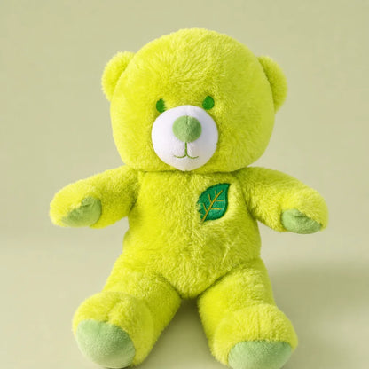 Lime green leaf teddy bear plush front view on a soft sage studio backdrop