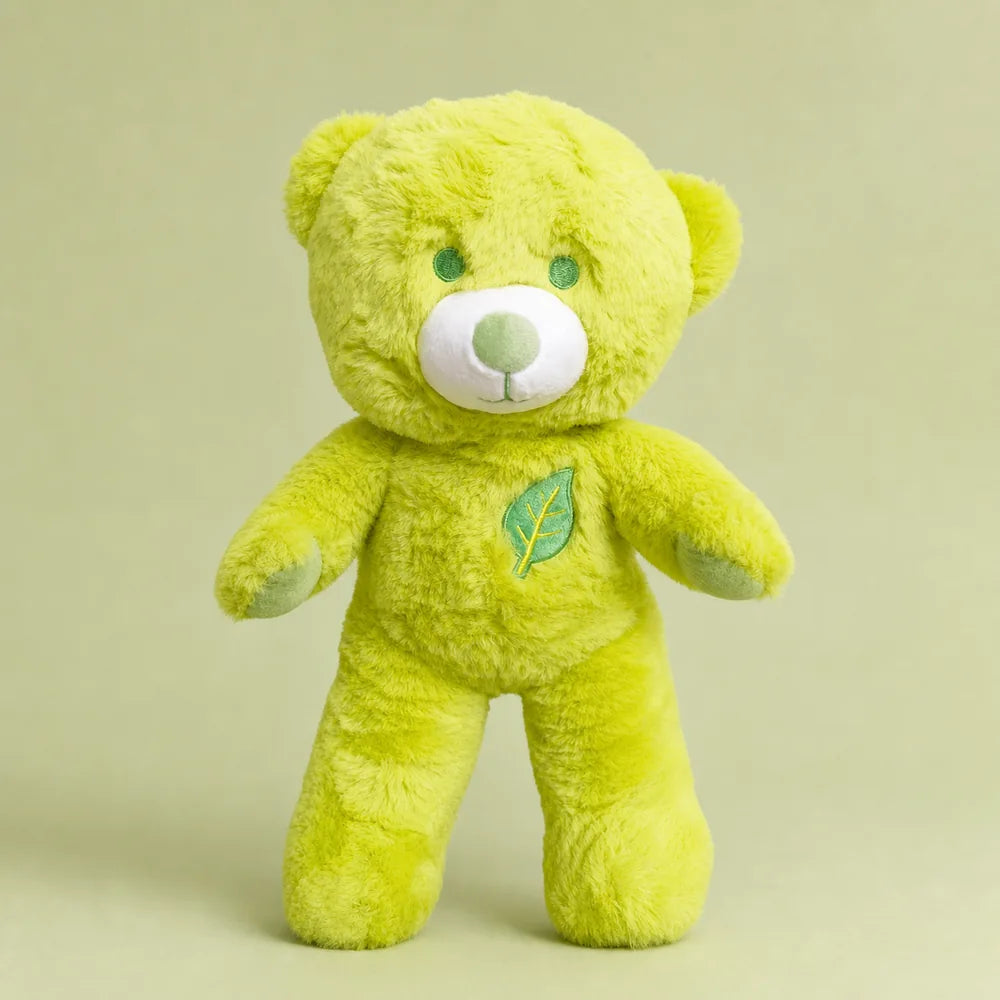 Lime green leaf teddy bear plush standing on a soft sage studio backdrop