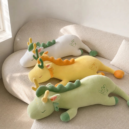 White Yellow and Mint Green Lovely Herbivore Dragon Plush Toys on a Cream Sofa