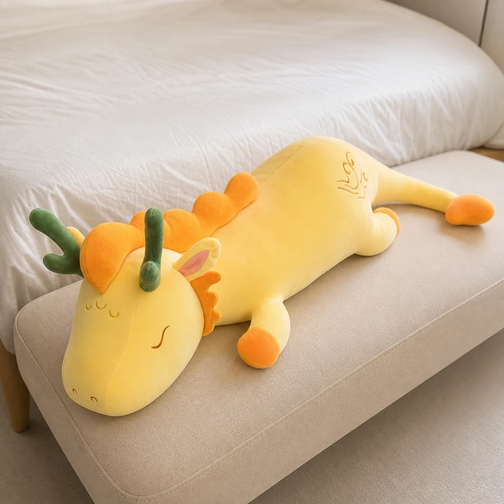 Yellow and Orange Lovely Herbivore Dragon Plush on a Cream Bedroom Bench