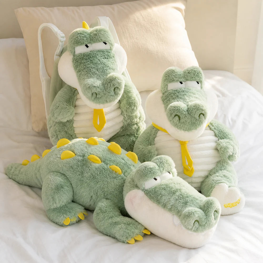 Mint green crocodile plush collection on a bright neutral bed