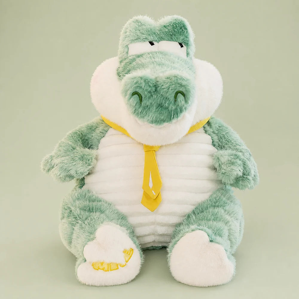 Mint green crocodile plush sitting upright on a sage studio backdrop